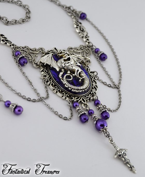 Purple fantasy dragon necklace close up taken from angle of dragon