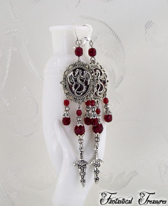 Red Dragon cameo earrings hanging on a vase